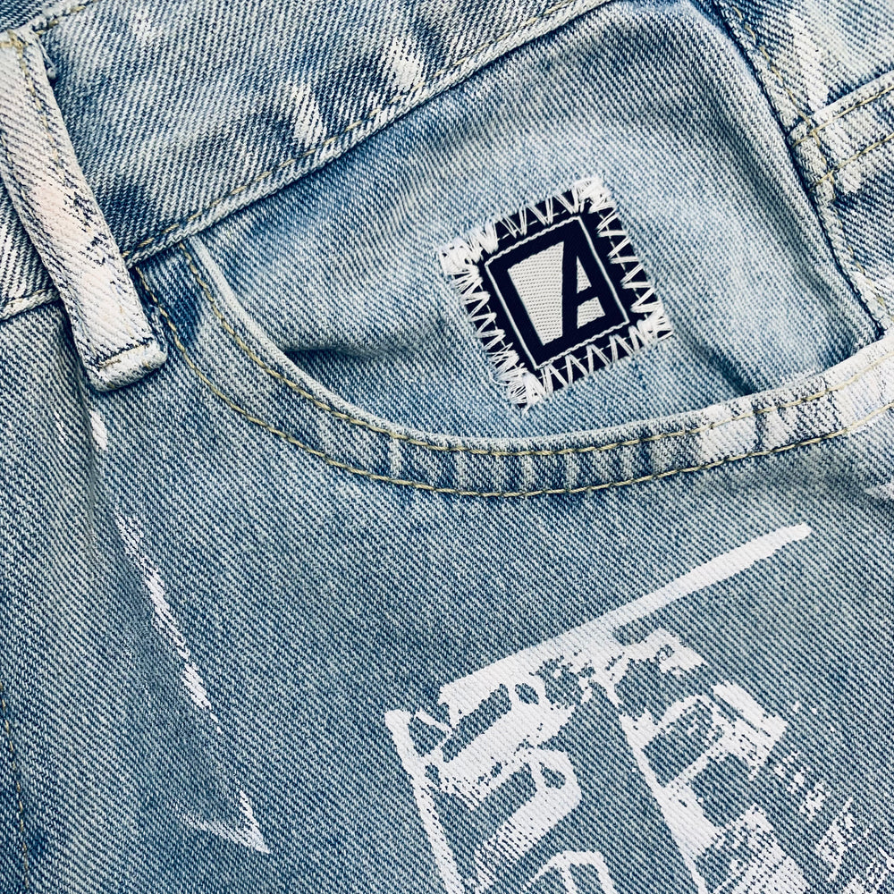 
                  
                    Jean serigraphie particulart logo
                  
                